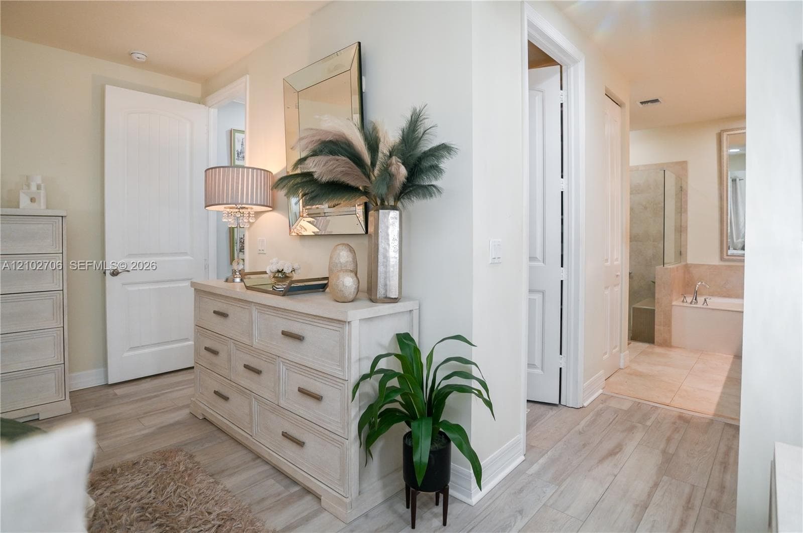 Wood-finish flooring, multi-panel interior doors, and neutral wall tones