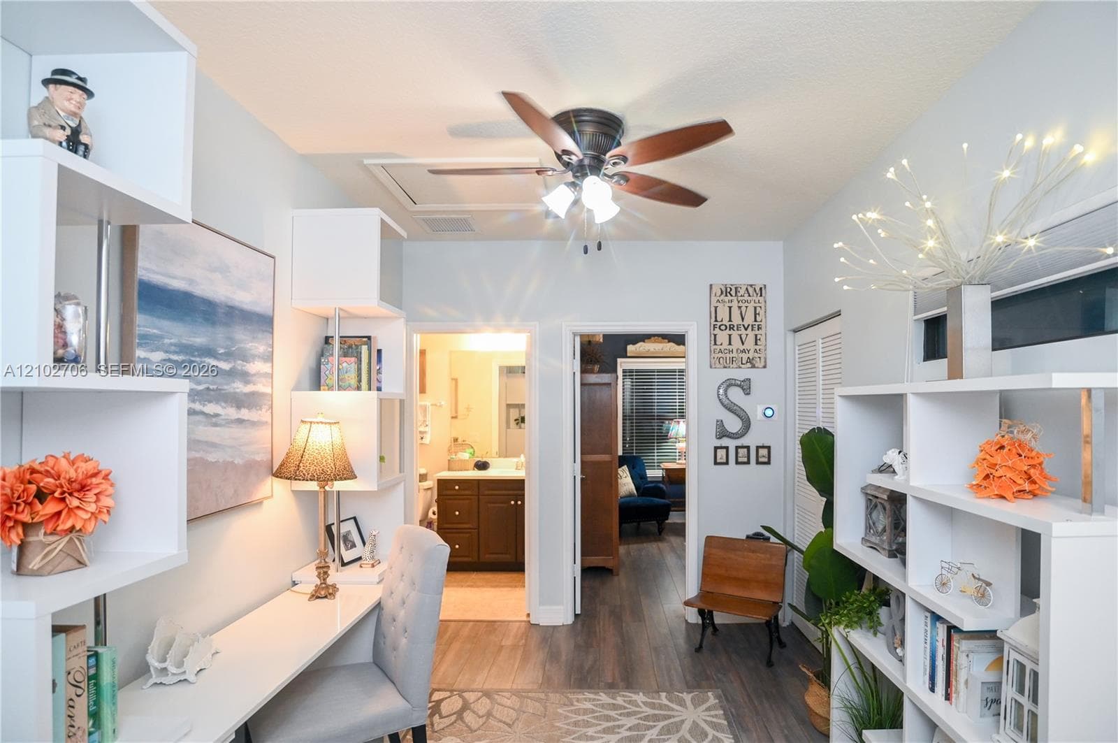 Built-in floor-to-ceiling wood-finish flooring, and a multi-blade ceiling fan with light fixture