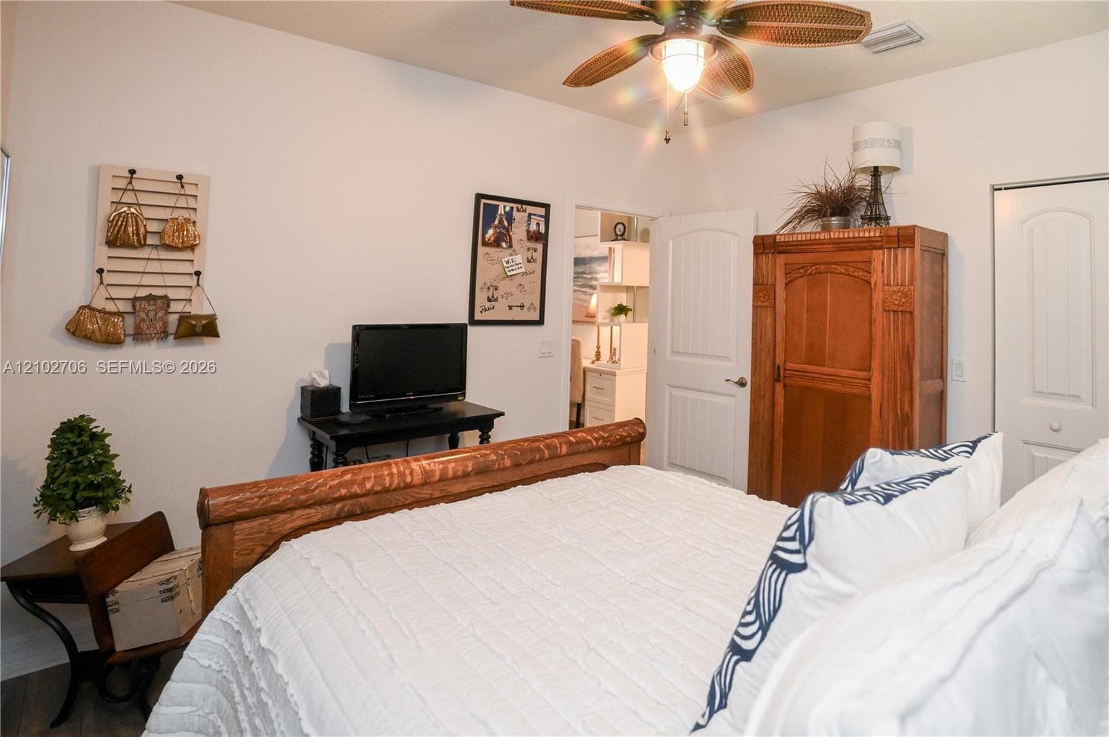 Room featuring neutral paint, a ceiling fan with light fixture, and two panel-style interior doors