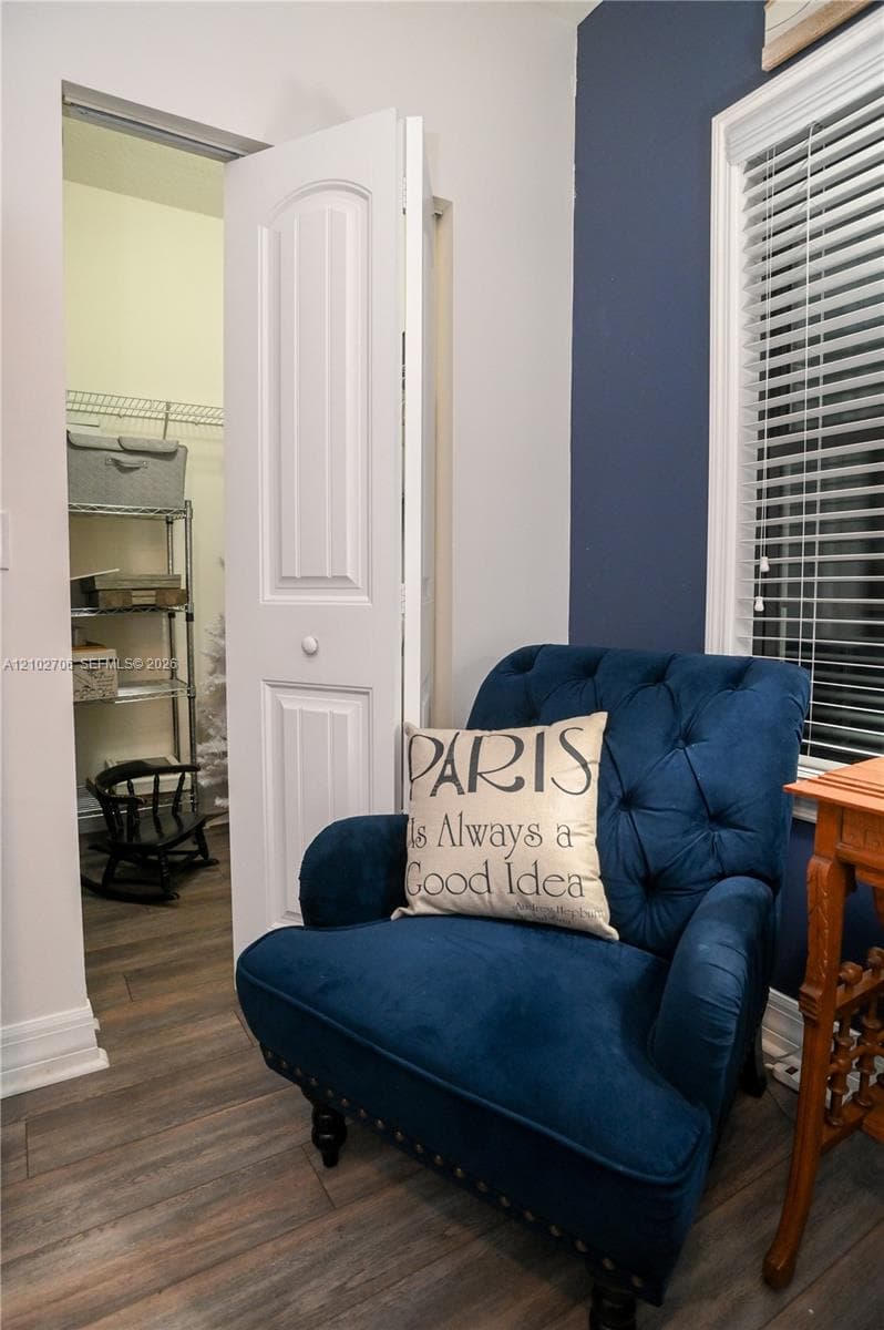 Wood-finish flooring, two-panel interior door, and window with integrated blinds