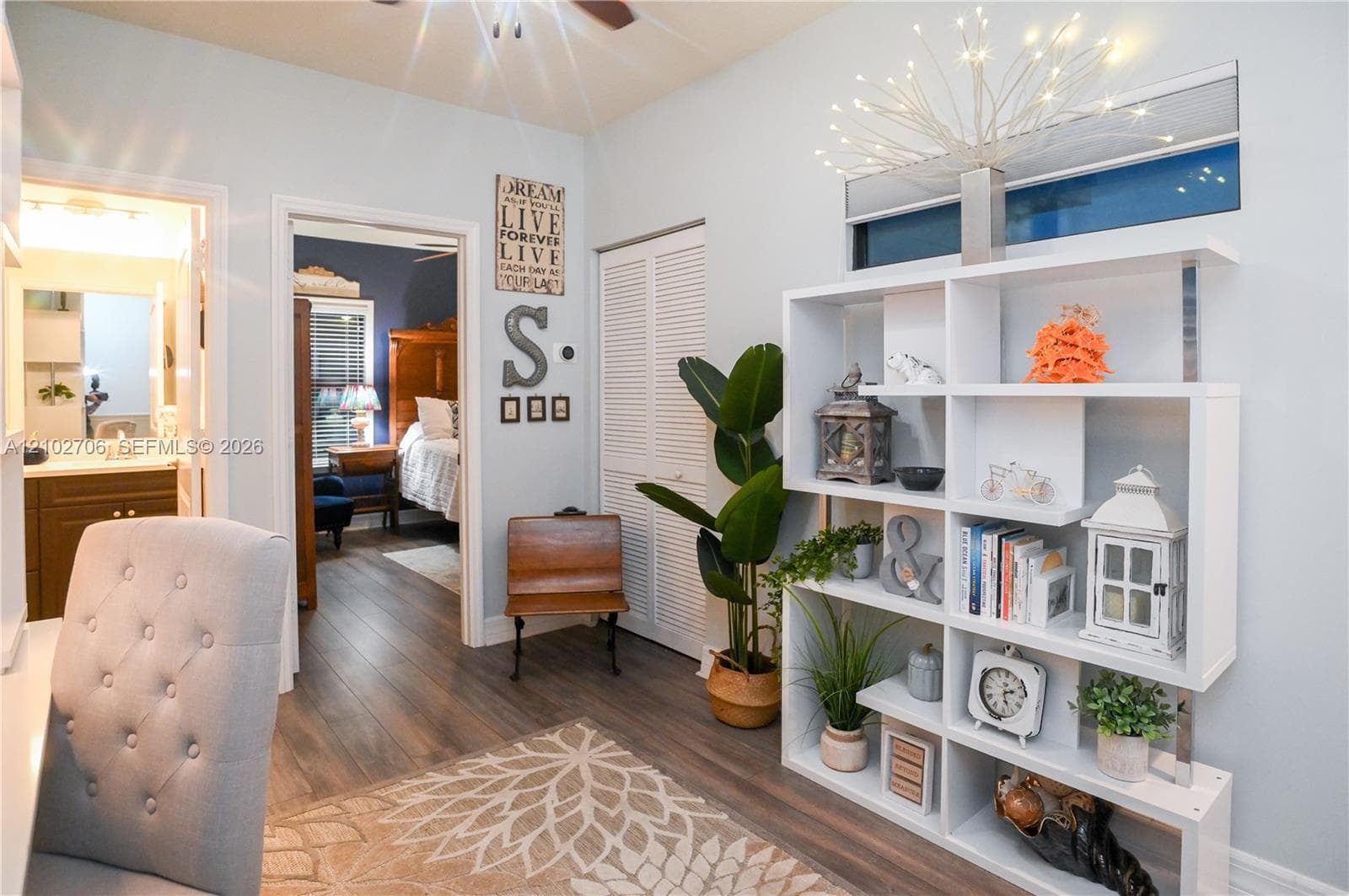 wood-finish flooring, and white louvered closet doors