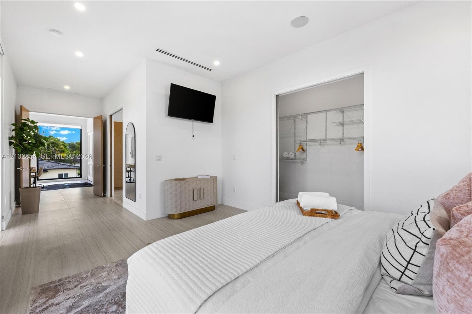 Wood-finish flooring, recessed lighting, and a closet with integrated wire shelving