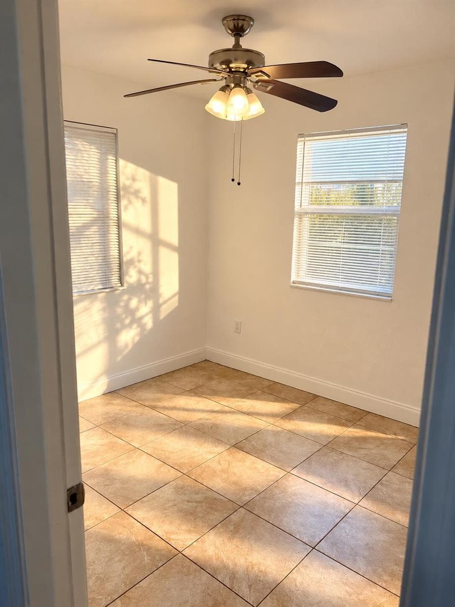 Sunlit Empty Room with Ceiling Fan
