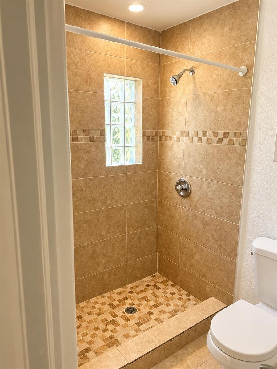 Warmly Lit Beige Tile Shower