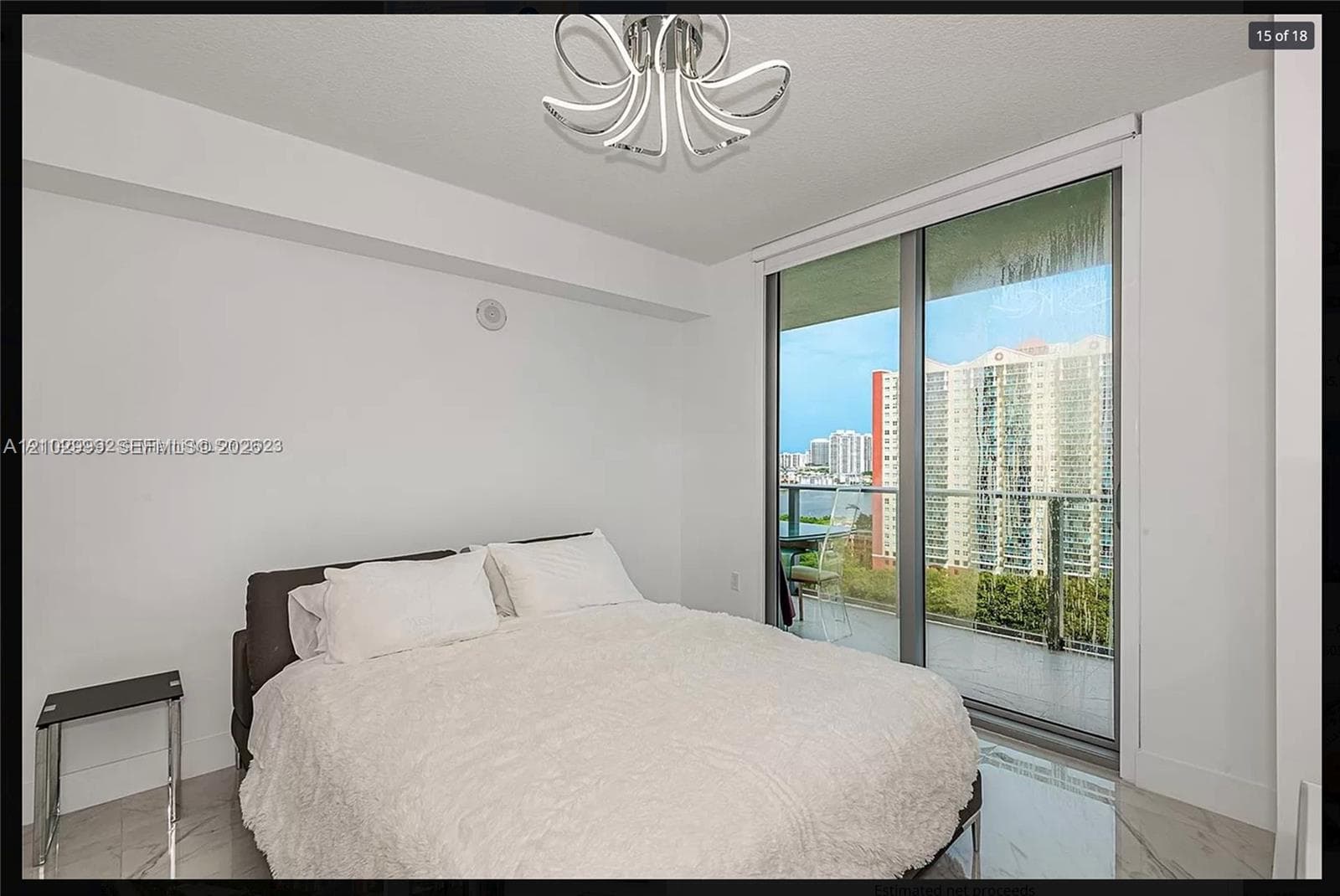Floor-to-ceiling sliding glass doors, contemporary overhead lighting, white walls, and light-tone flooring