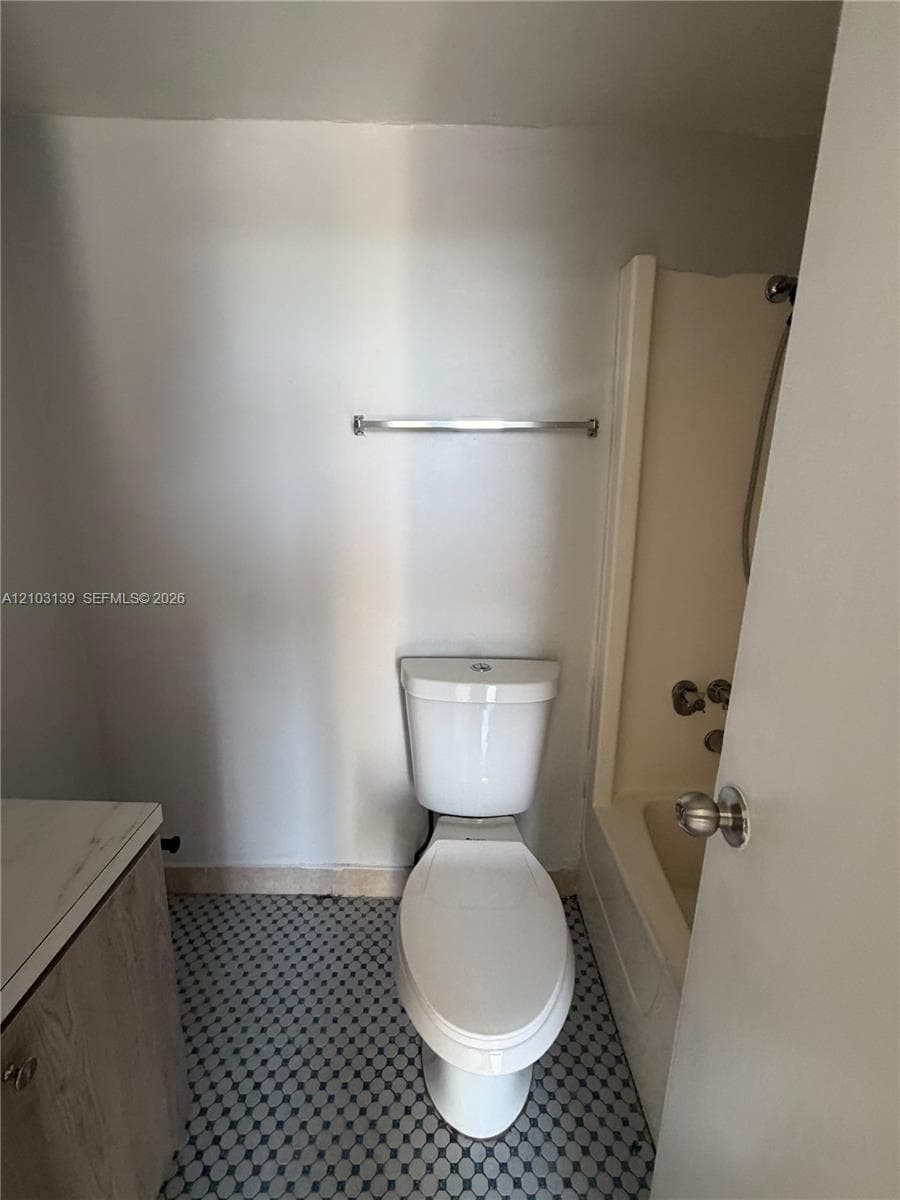 White toilet with a chrome towel bar