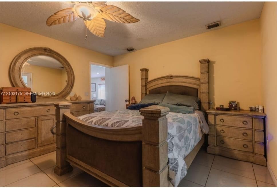 Room featuring tile flooring and an integrated ceiling fan with decorative leaf-shaped blades