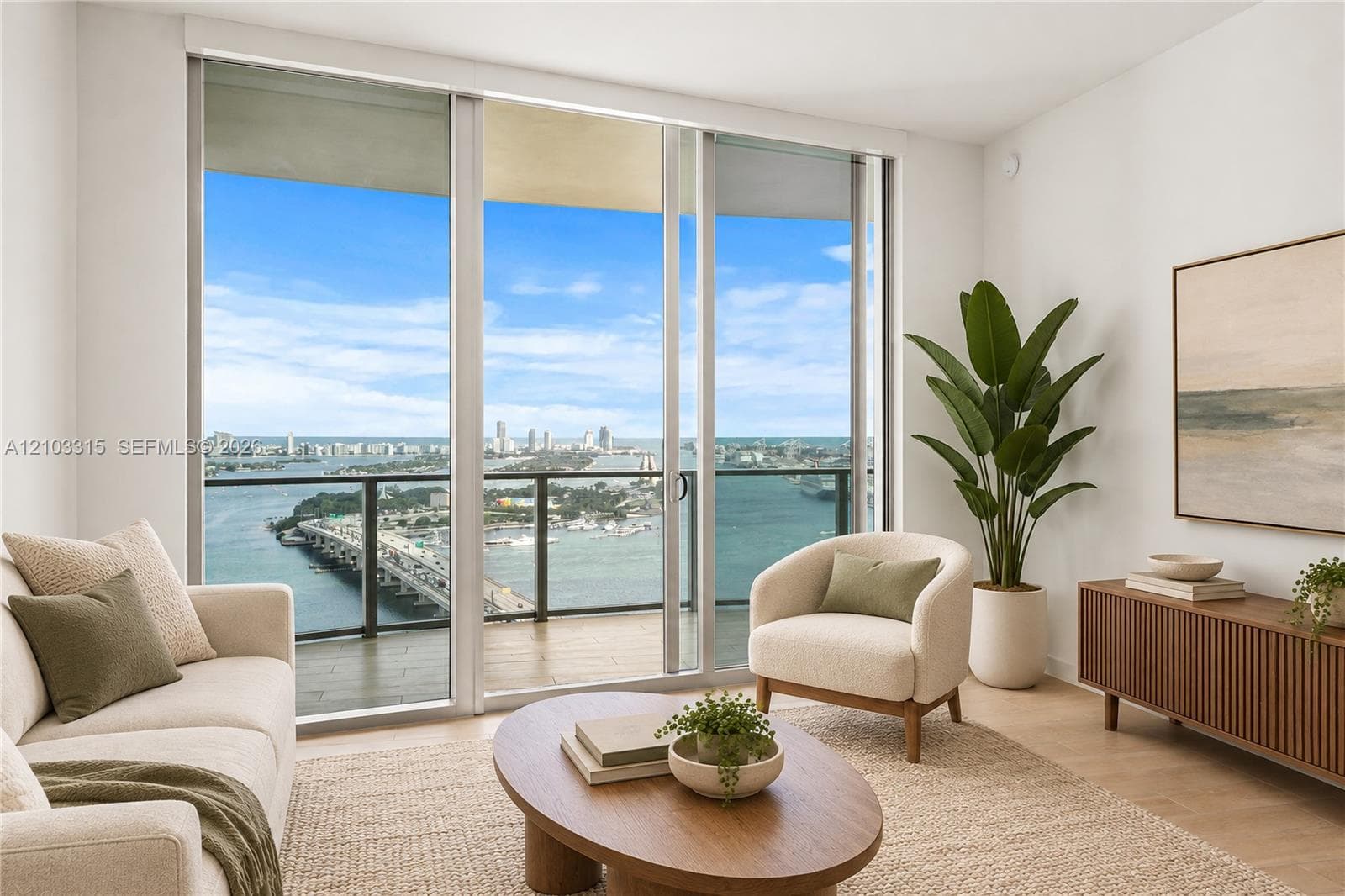 Expansive sliding glass doors, balcony access with glass railings, wood-finish flooring, and white walls