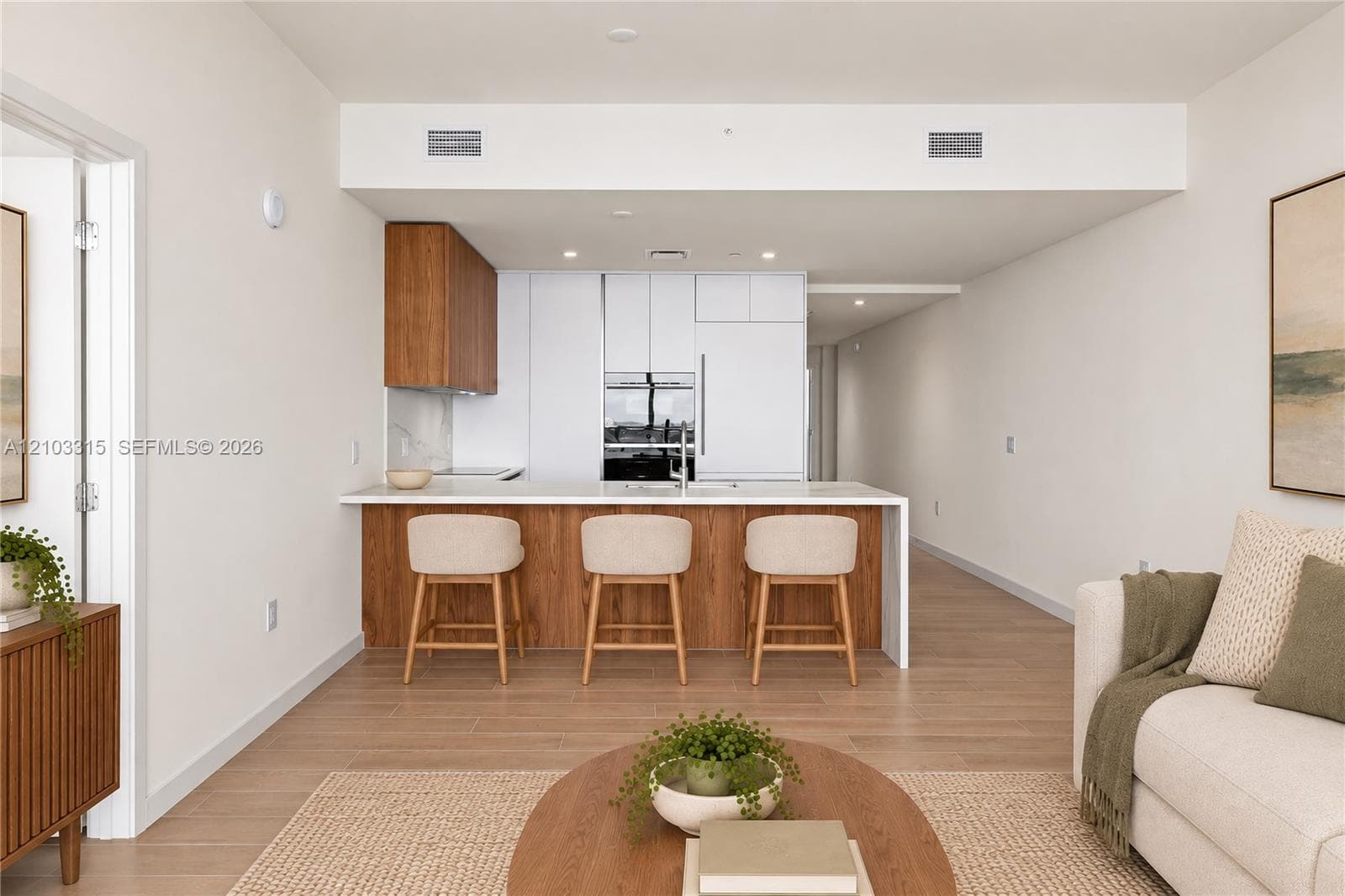 Modern kitchen island featuring a white countertop and wood-finish paneling