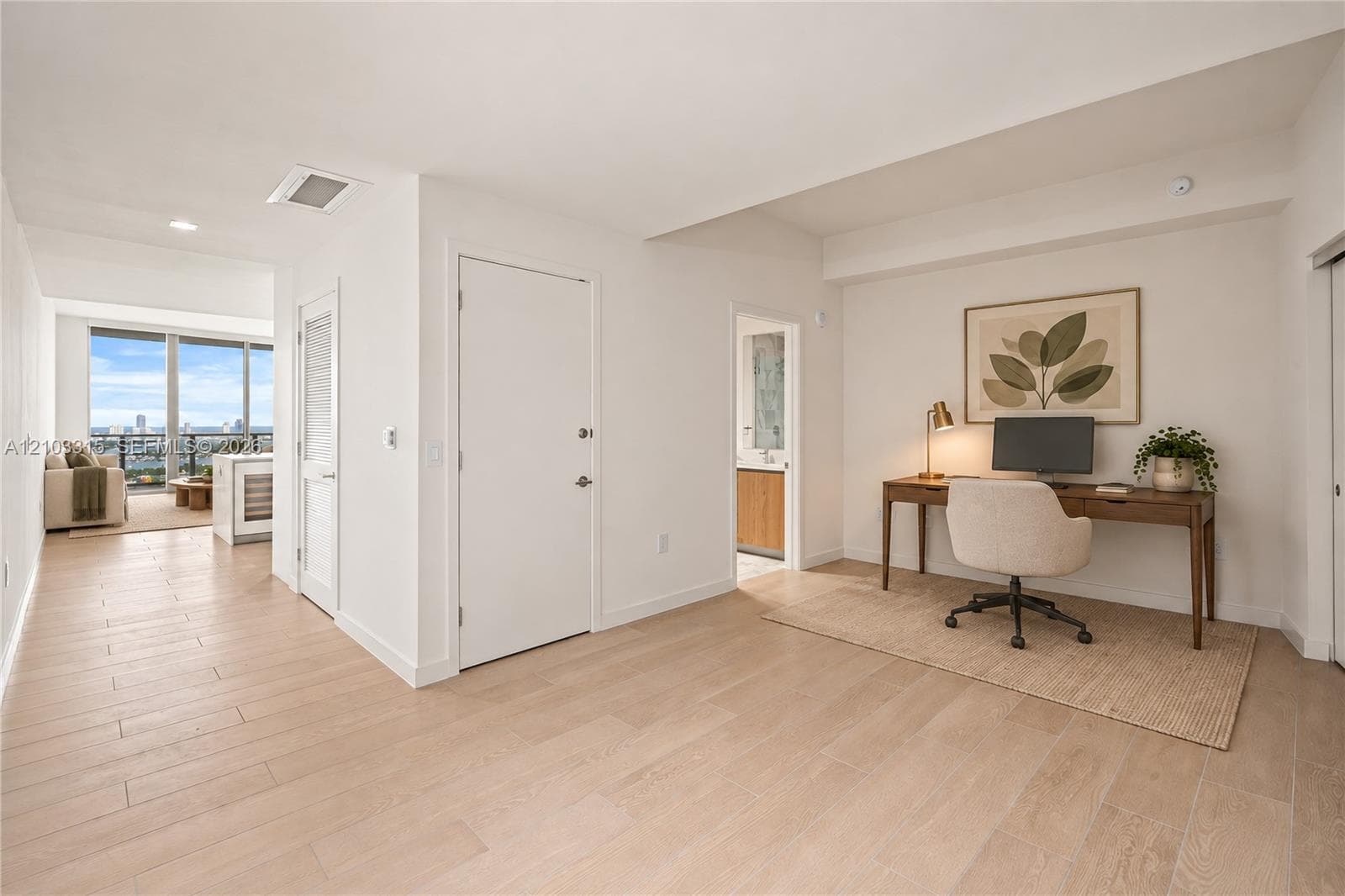 Light-toned wood-finish flooring throughout, recessed lighting, white walls, and a built-in wine refrigerator