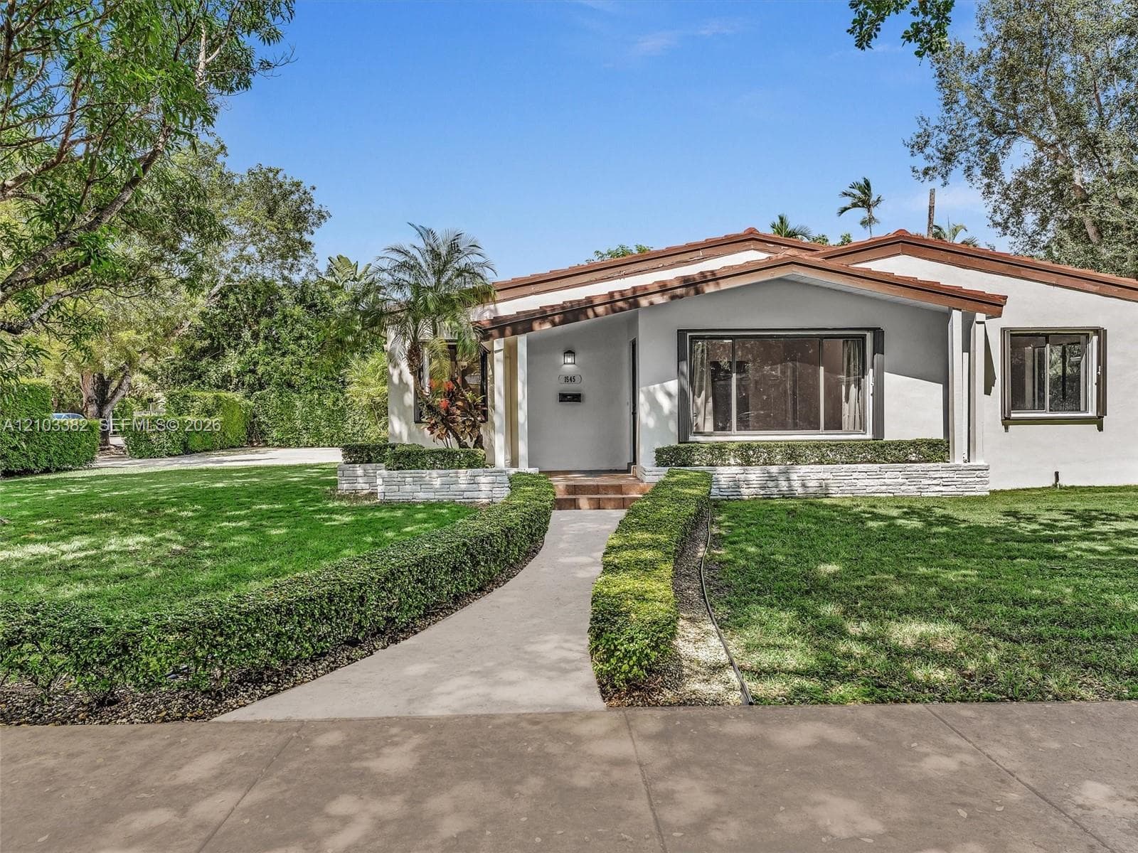 Single-story house set deep on a large lot in Coral Gables within walking distance to University of Miami and minuted from South Miami shops/ cafes. Stucco exterior w/ stacked stone accents,a paved walkway and wide-frame windows, covered porch, and mature trees on a manicured lot. House for rent in Coral Gables. House for rent listed by Realtor