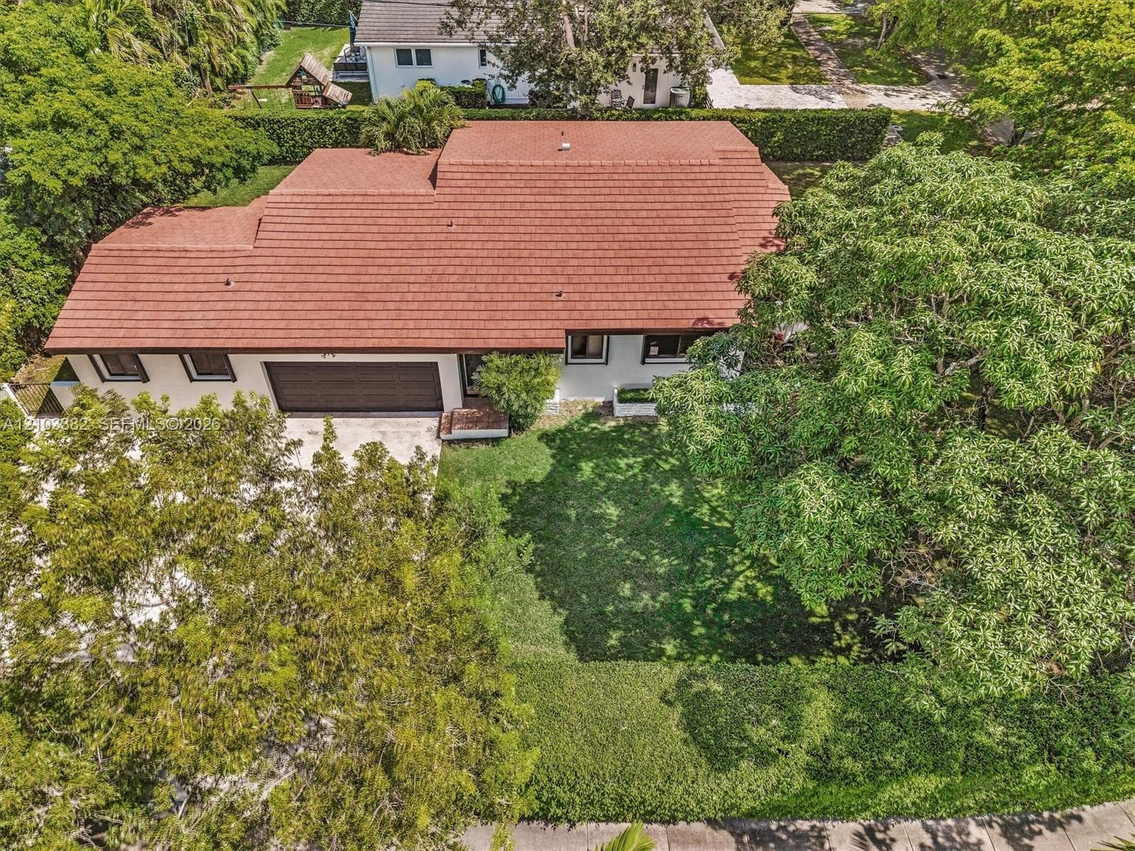 Single-story house for rent on a huge corner lot, featuring a tile roof, an attached two-car garage, and established landscaping.House for rent in Coral Gables. House for rent listed by Realtor.