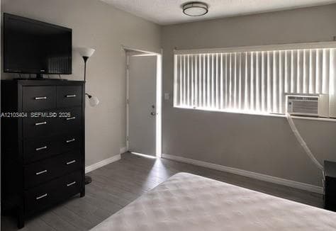 Neutral wall finishes, wood-finish flooring, and a flush-mount ceiling light fixture