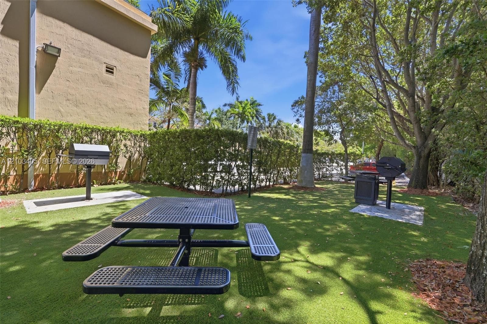 Multi-story exterior featuring a terracotta tile roof, dual-tone stucco facade, arched entryways, and private balconies