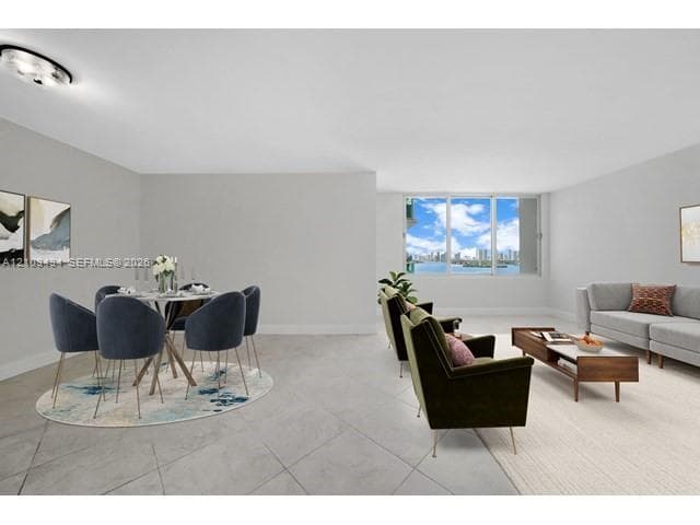 Open-concept floor plan with neutral wall finishes, tile flooring, large multi-pane window, and integrated overhead lighting fixture