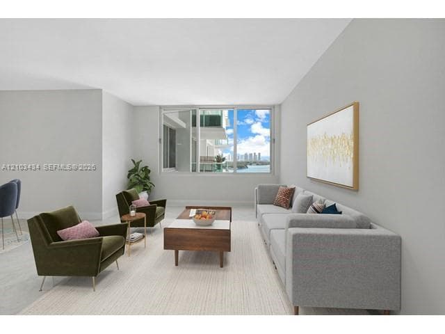 Living area featuring neutral wall paint, smooth-finish ceiling, and large sliding glass windows