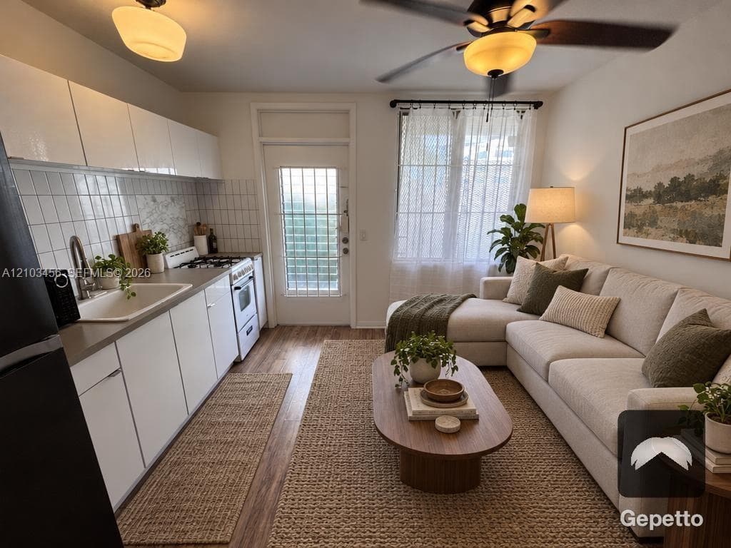 Kitchen featuring flat-panel white cabinetry, square tile backsplash, wood-finish flooring, and a ceiling fan with integrated lighting