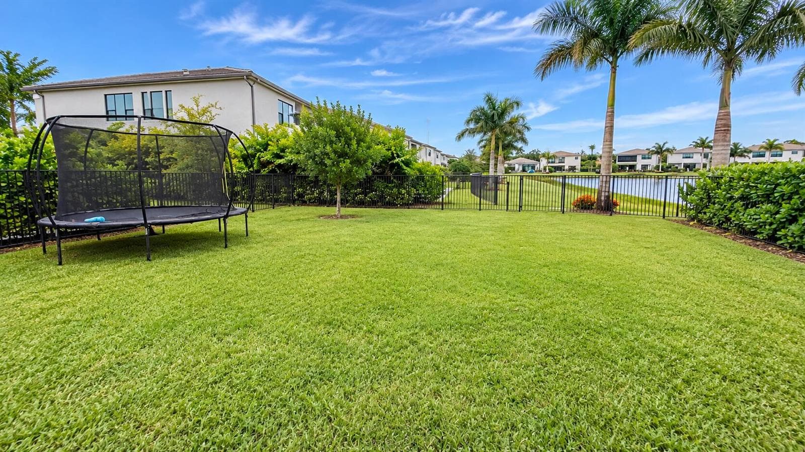 Sunny Waterfront Backyard with Trampolin