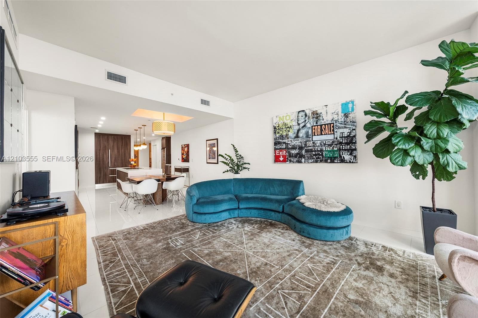 Open-concept living space featuring high ceilings, recessed lighting, and tile flooring