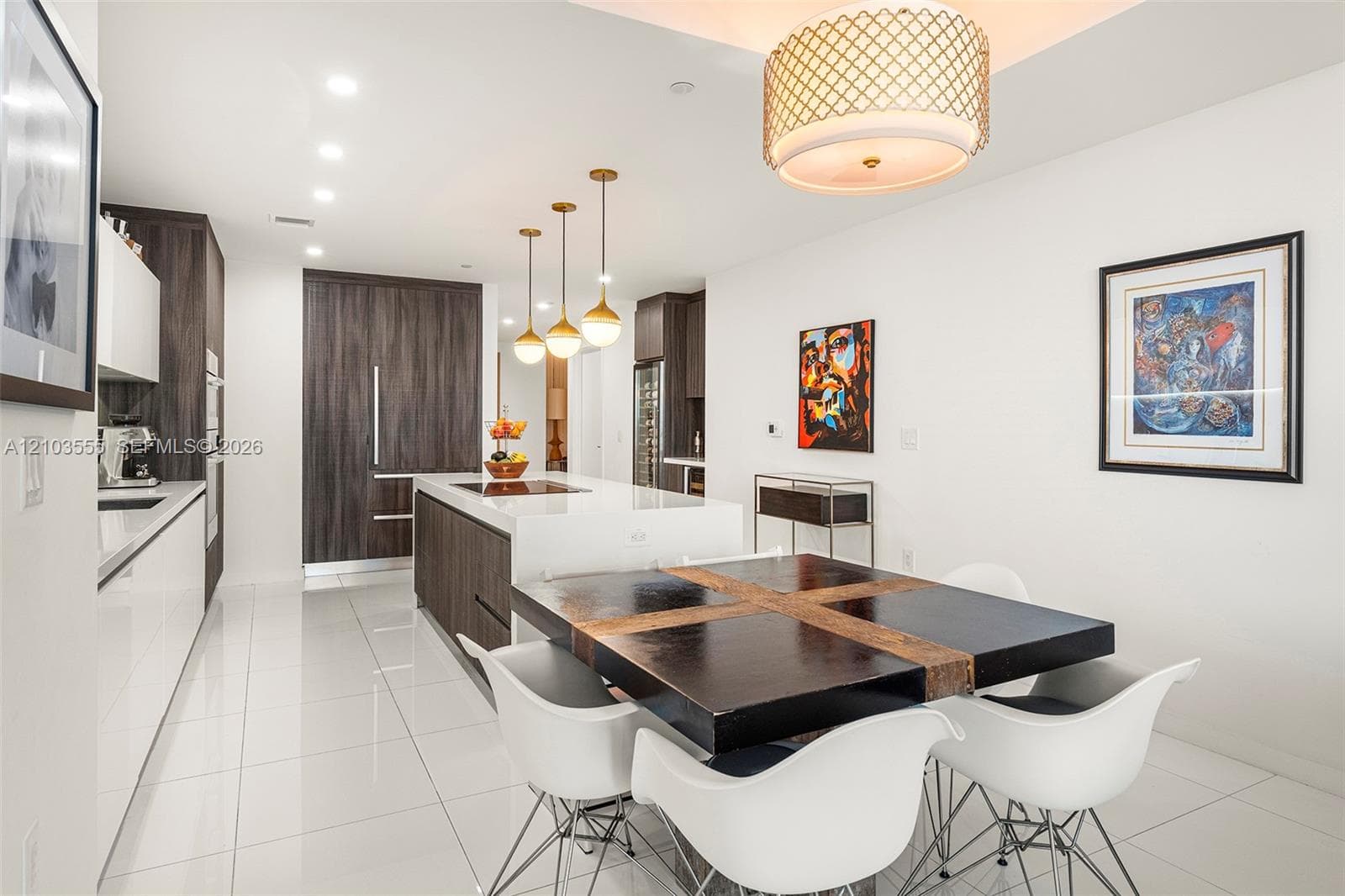 Kitchen with white tile flooring, recessed ceiling lighting, a center island, and wood-finish cabinetry