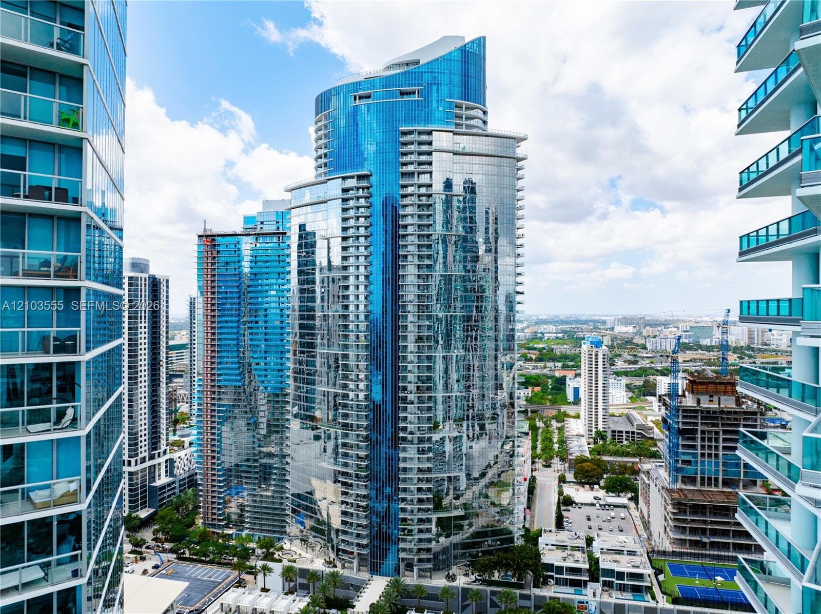 Modern high-rise architecture featuring extensive glass facades and multiple balconies