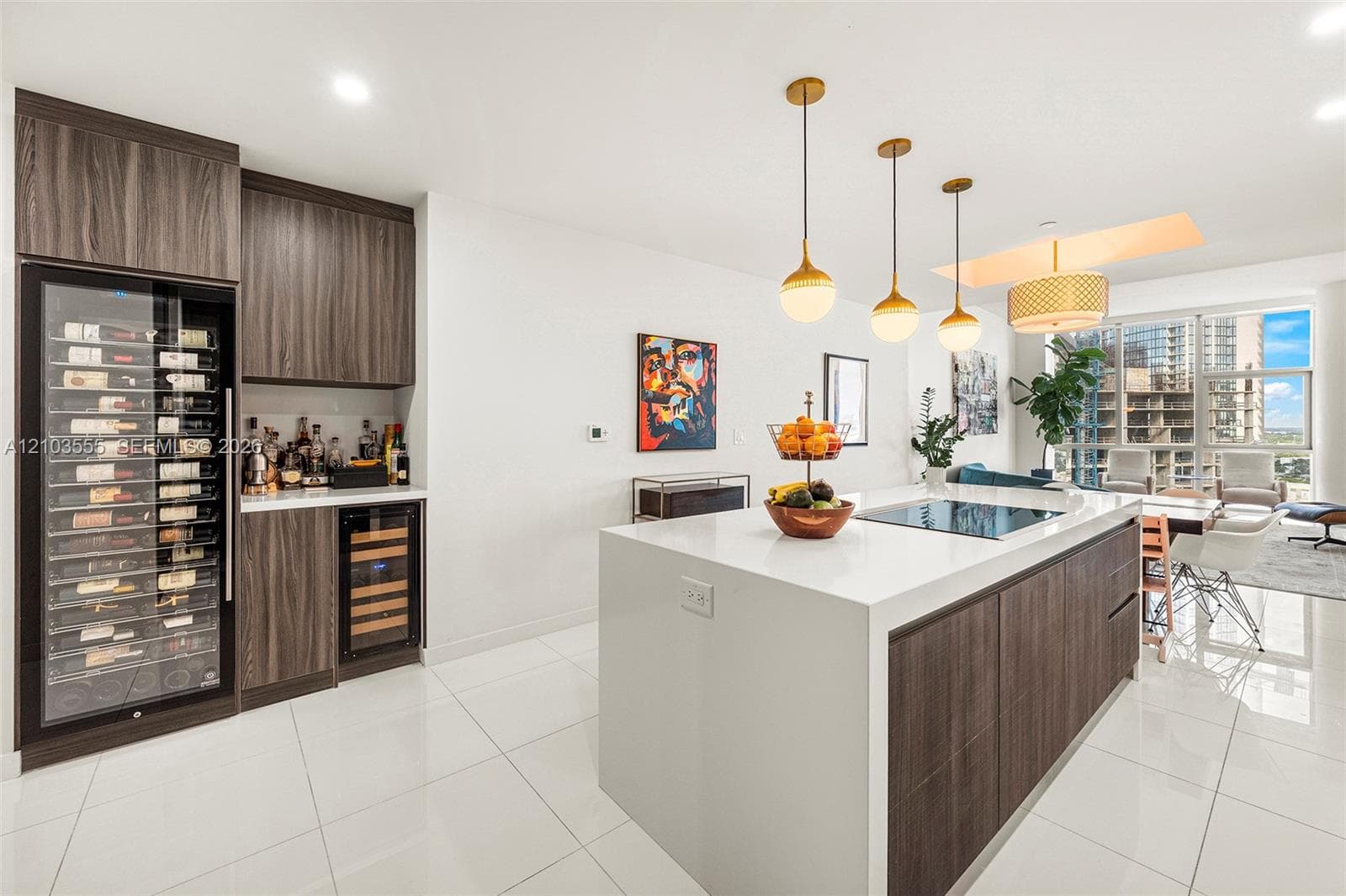 Modern kitchen island featuring a smooth cooktop and pendant lighting