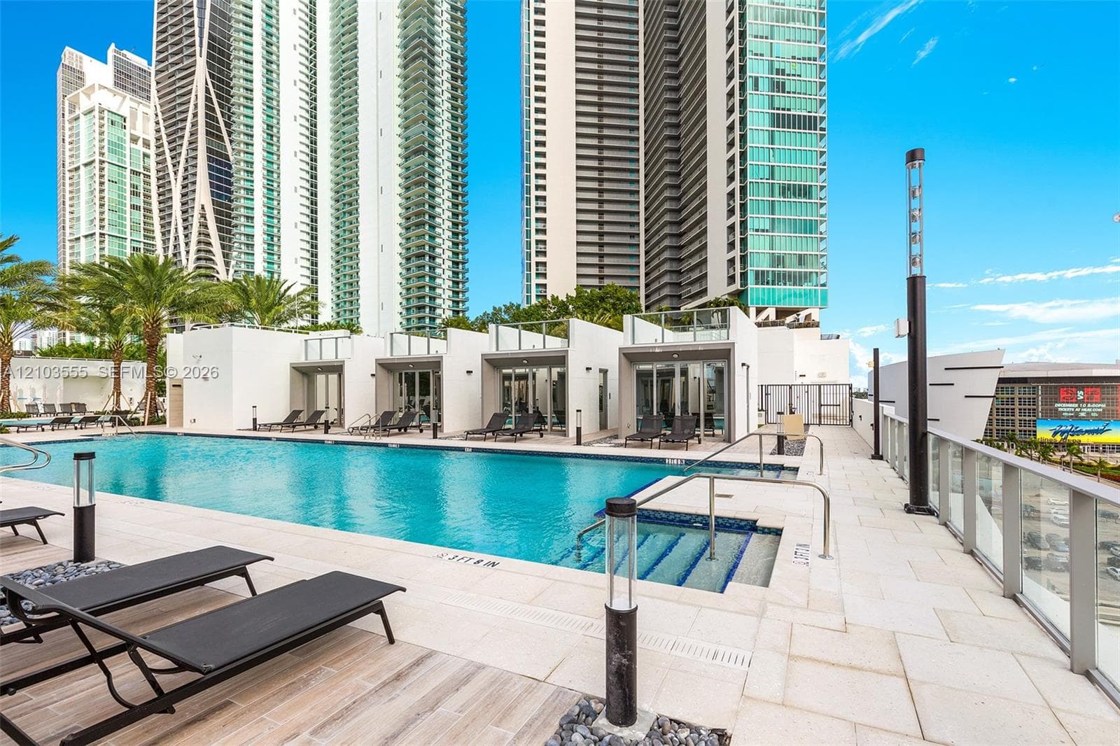 Expansive outdoor pool with integrated spa and contemporary poolside structures