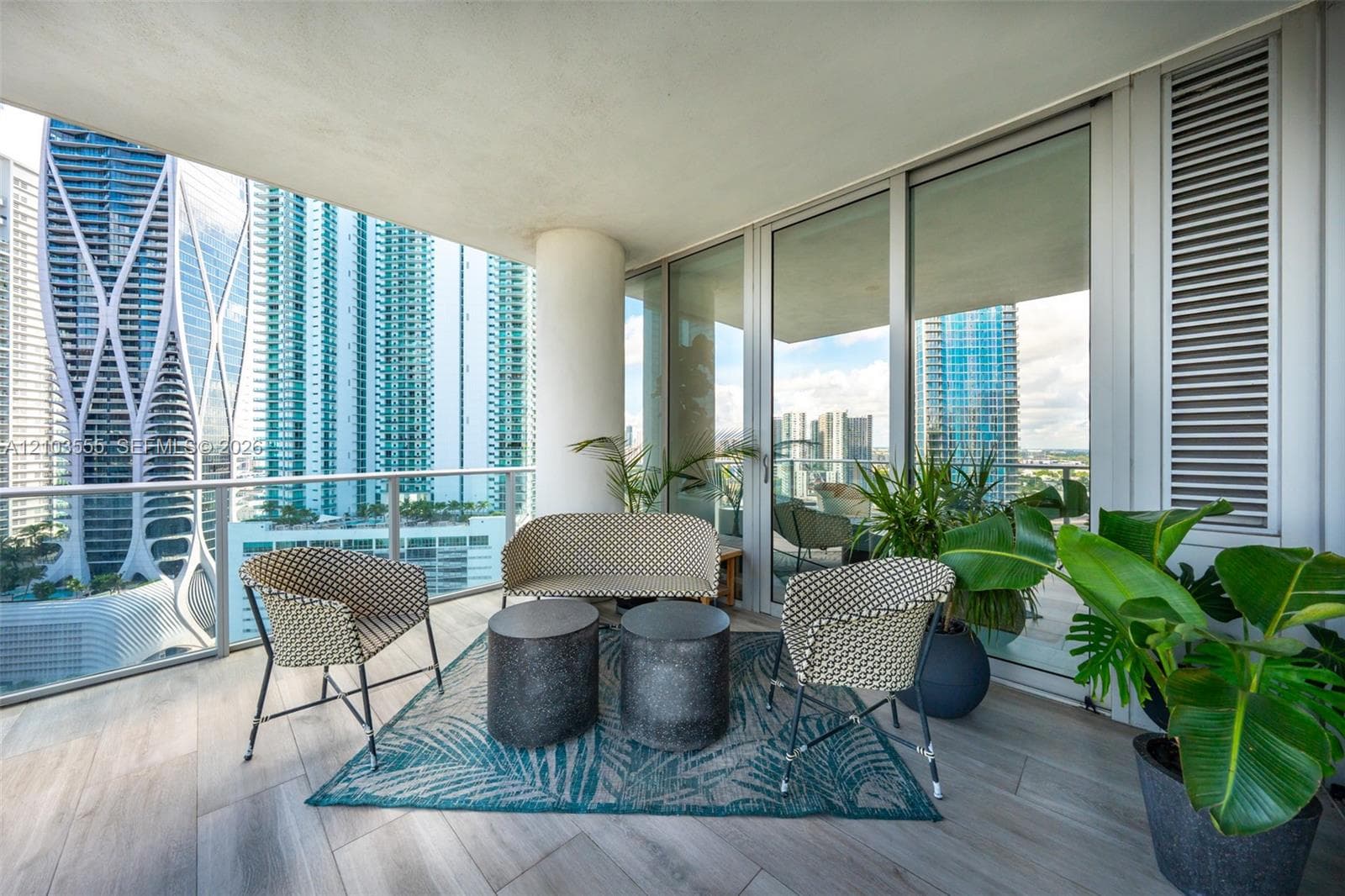 Expansive balcony featuring wood-finish flooring and a glass railing