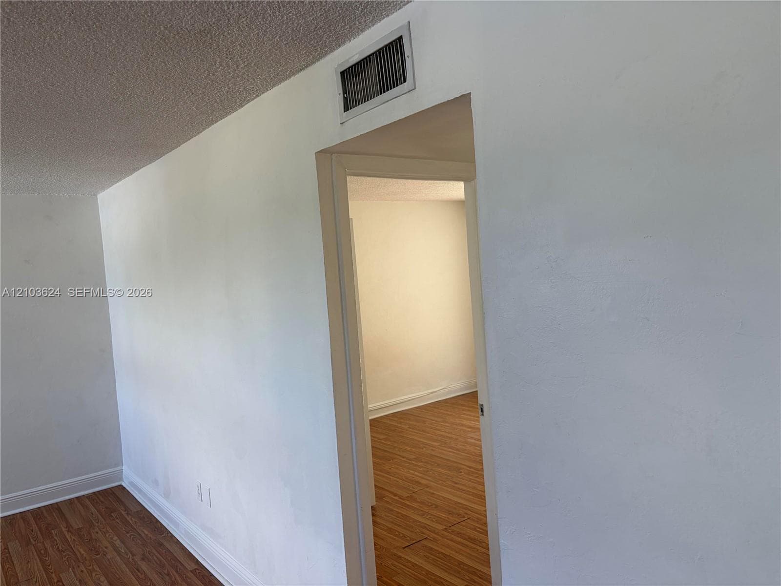 Interior space featuring neutral wall finishes and wood-finish flooring