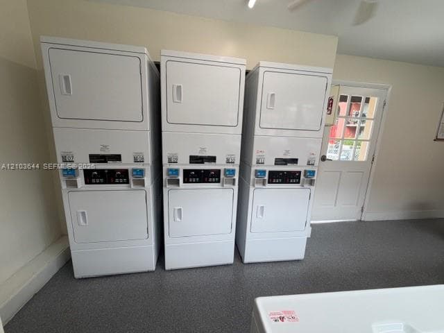 Laundry facility featuring three commercial-grade stackable washer-dryer units, gray speckled flooring, and a multi-pane glass entry door