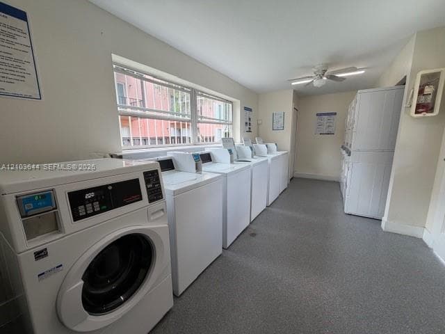 Communal laundry facility featuring multiple commercial-grade front-load washers, stackable dryer units, durable vinyl flooring, and a ceiling-mounted fan
