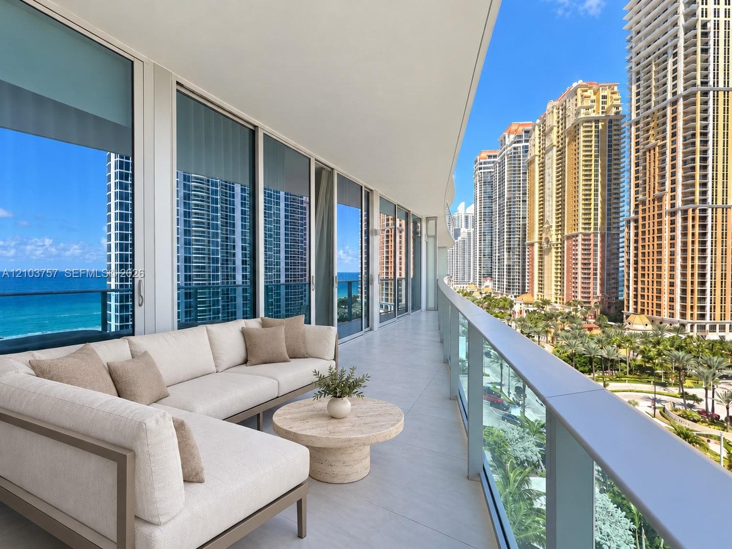 Expansive balcony featuring floor-to-ceiling sliding glass doors, a glass railing, and tiled flooring
