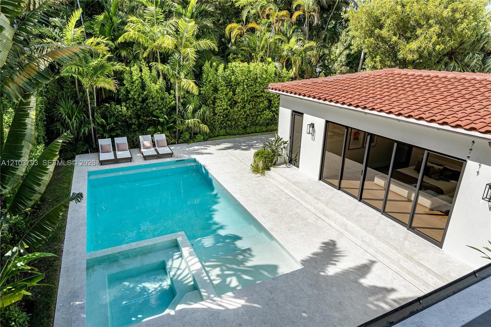 Neutral wall finish, wood-finish flooring, recessed lighting, and black-framed windows