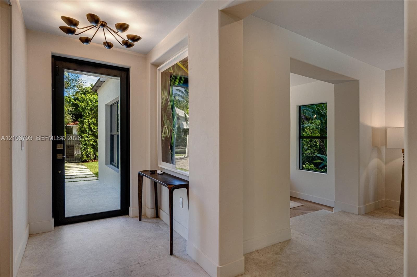 Textured plaster wall finishes, inset wall mirror, and wood-finish flooring