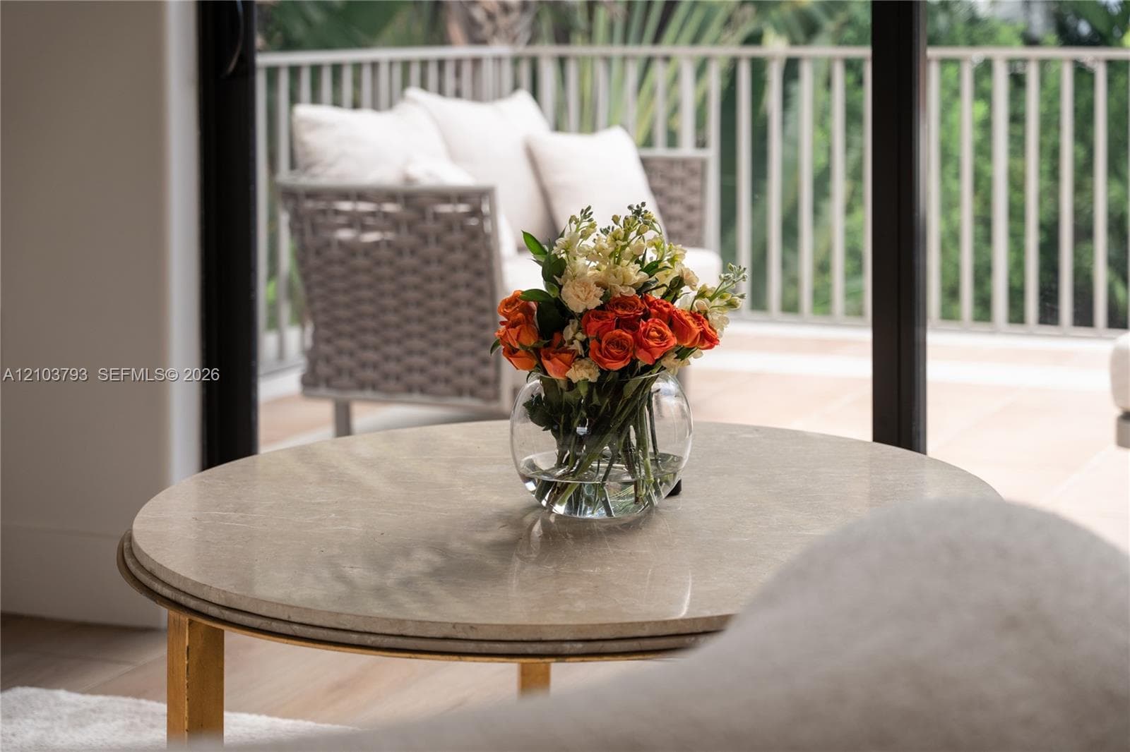 Second-story balcony featuring terracotta tile flooring, metal railings, and built-in concrete planters