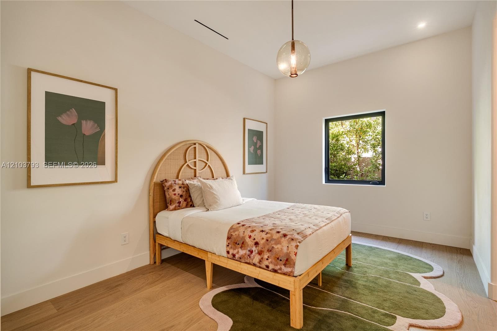 Interior space featuring recessed lighting, a single-pane window with black framing, and wood-finish flooring