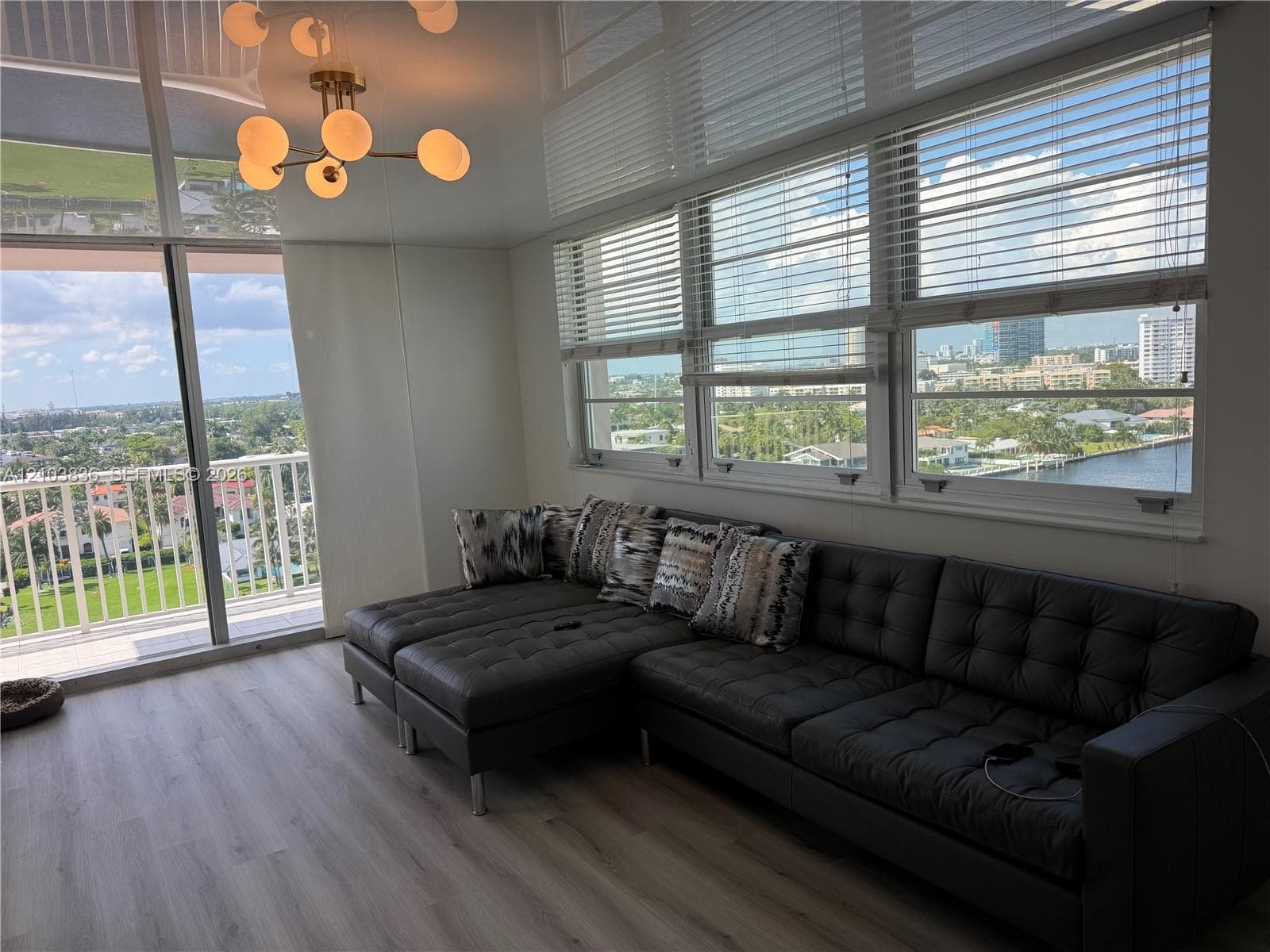 Light wood-finish flooring with a modern ceiling-mounted light fixture