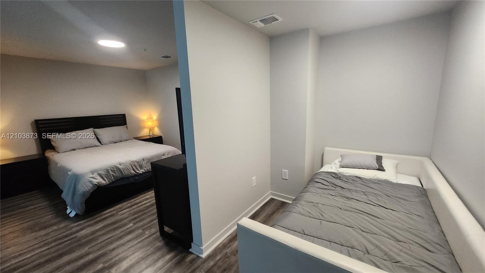 Interior space featuring neutral wall paint and wood-finish flooring