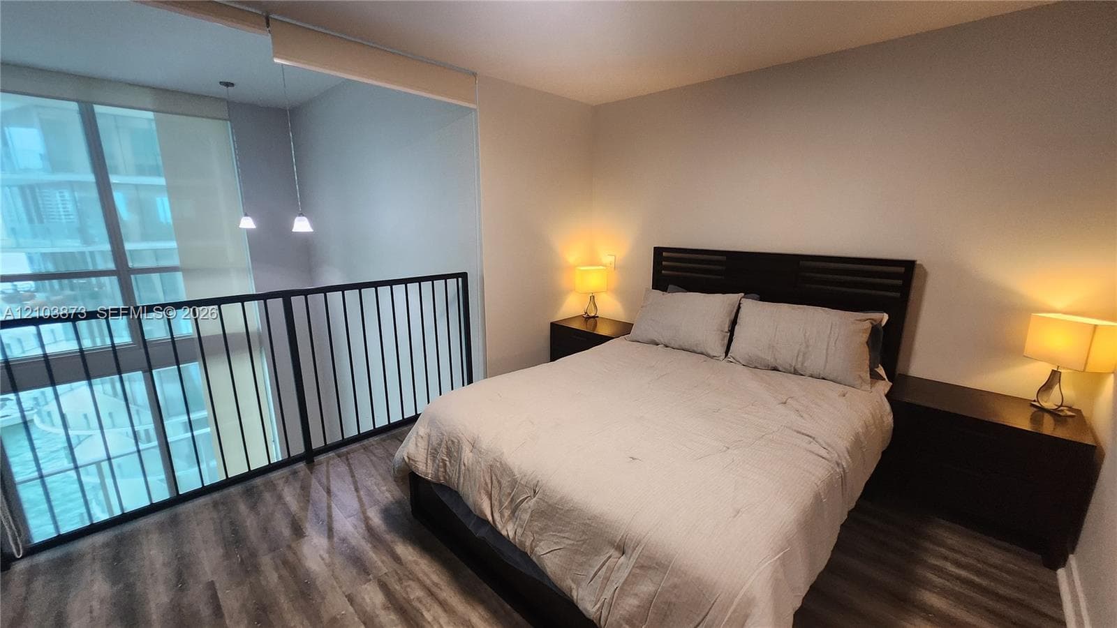 Wood-finish flooring, floor-to-ceiling windows, and a metal safety railing