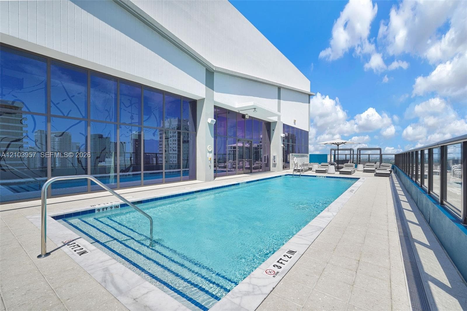 Rooftop swimming pool with integrated entry steps and stainless steel handrail