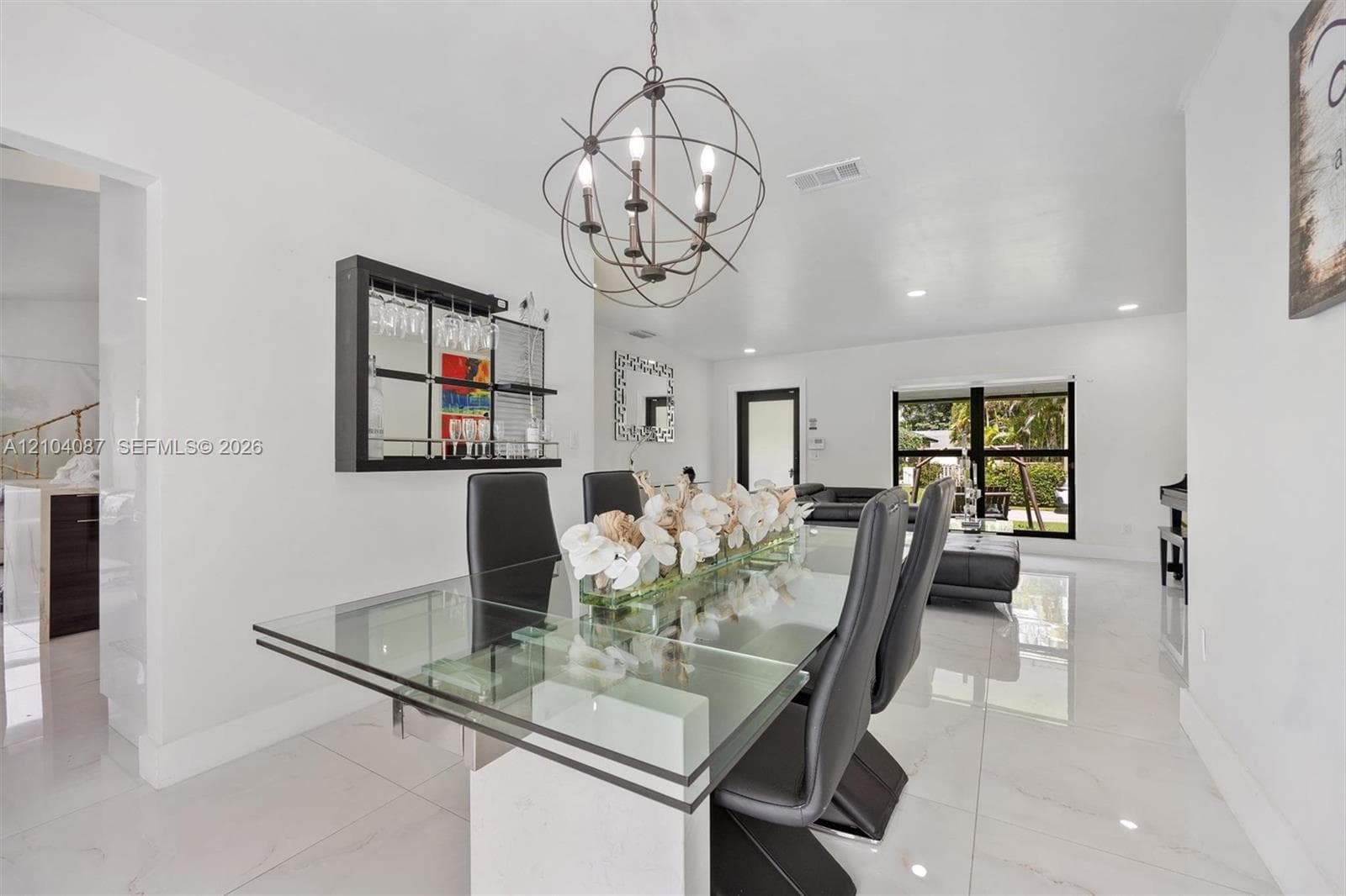 White tile flooring throughout, with a glass-top dining table