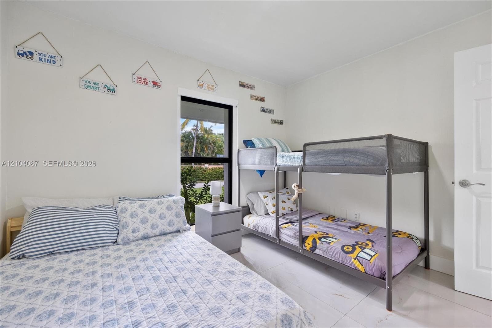 White walls with a single window featuring a dark frame