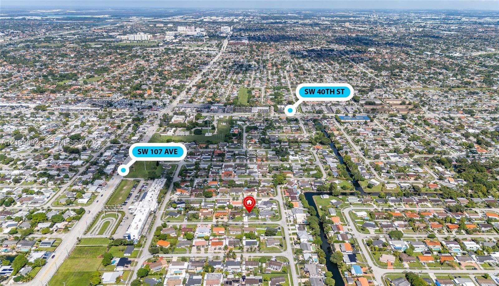 Aerial perspective of the residential property situated in a grid-patterned neighborhood with proximity to major thoroughfares