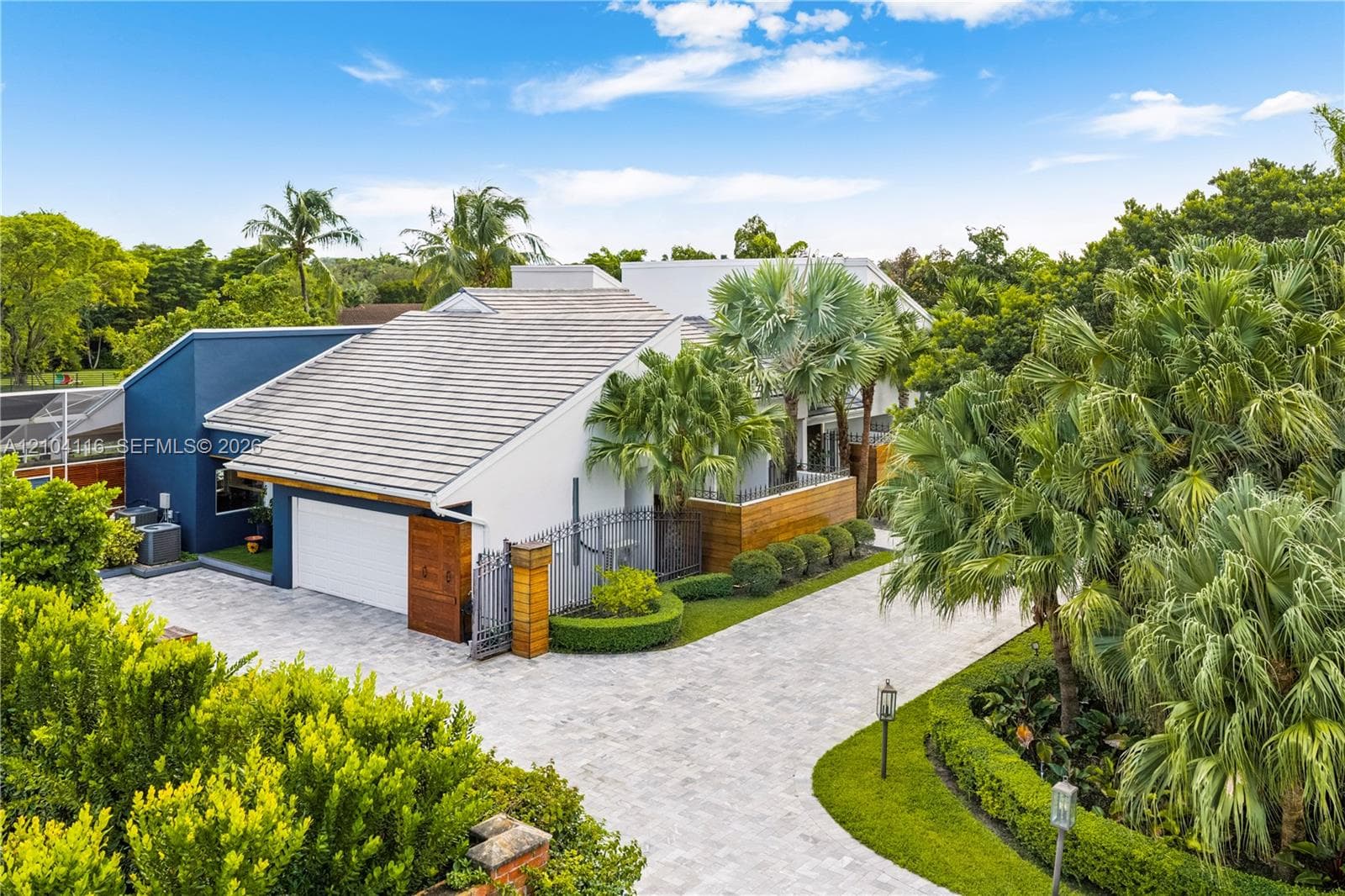 Front and side of the house with plenty of parking and an oversized 2 car garage