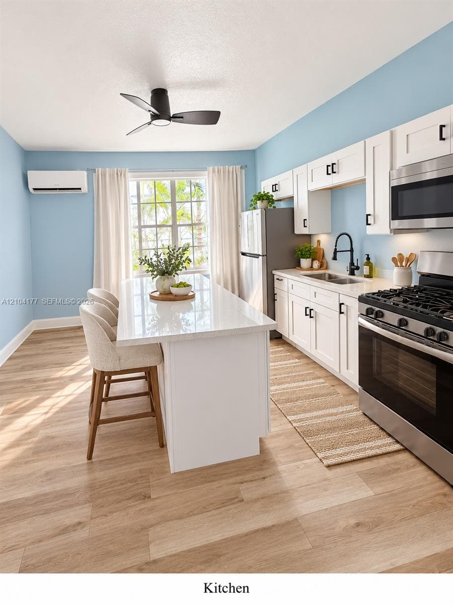 Kitchen featuring white shaker-style cabinetry, quartz countertops, a central island, wood-finish flooring, and a matte black gooseneck faucet