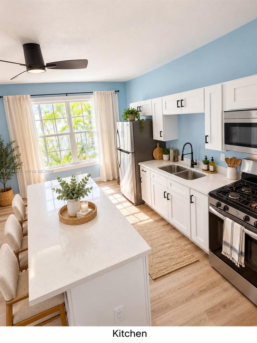 Kitchen featuring white shaker cabinetry, quartz countertops, a large island with seating, stainless steel appliances, and a matte black gooseneck faucet