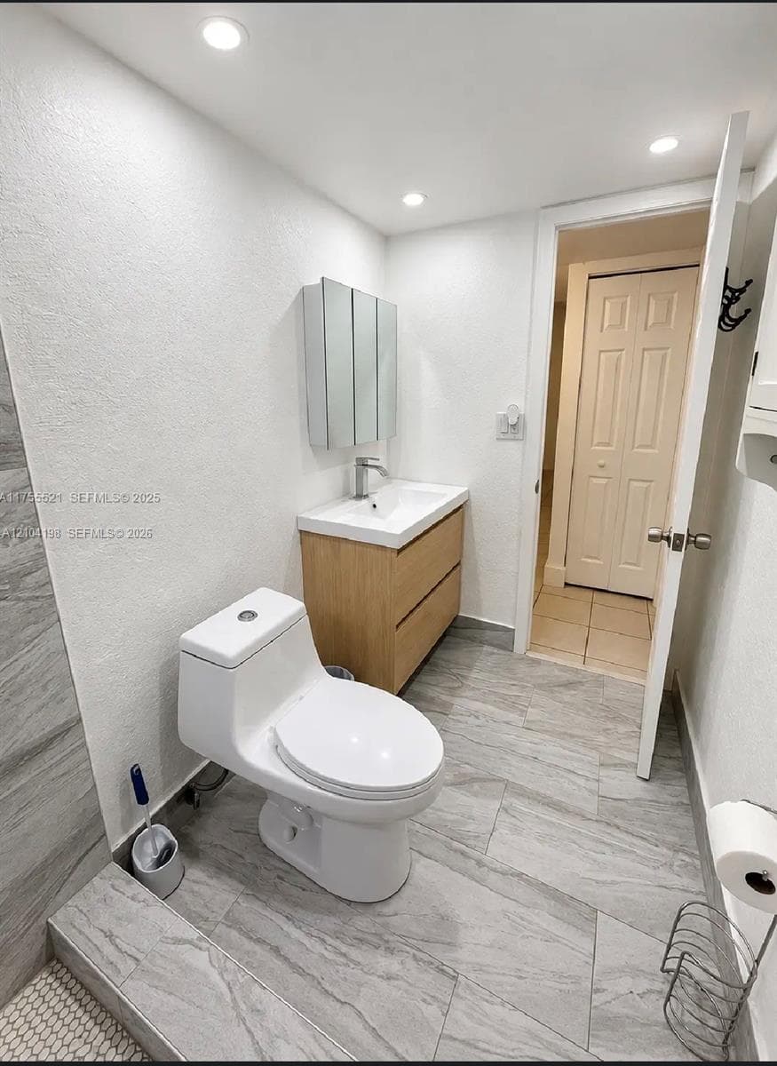 Neutral-toned tile flooring, bi-fold closet doors, and multi-panel interior doors