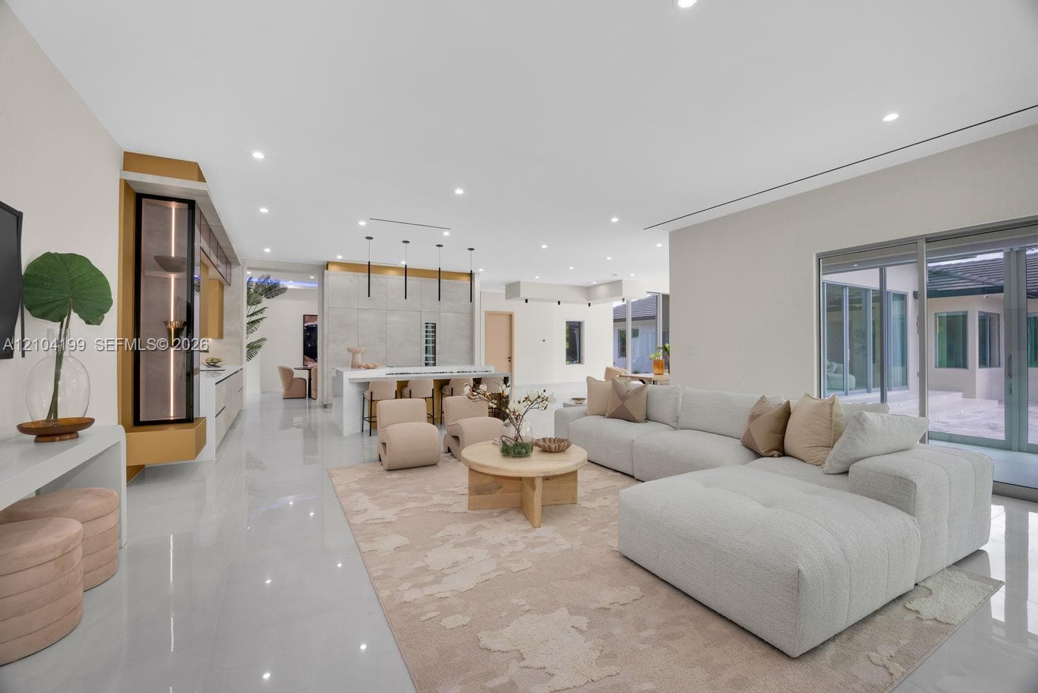 Spacious interior featuring large-format tile flooring, recessed lighting, expansive glass windows, and minimalist trim-less door frames