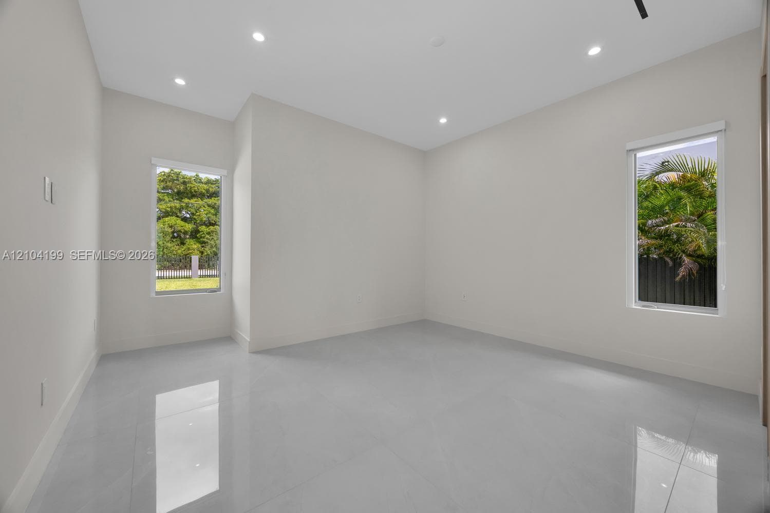 Neutral-toned interior featuring large-format tile flooring, recessed lighting, and a walk-in closet equipped with custom built-in shelving and drawers