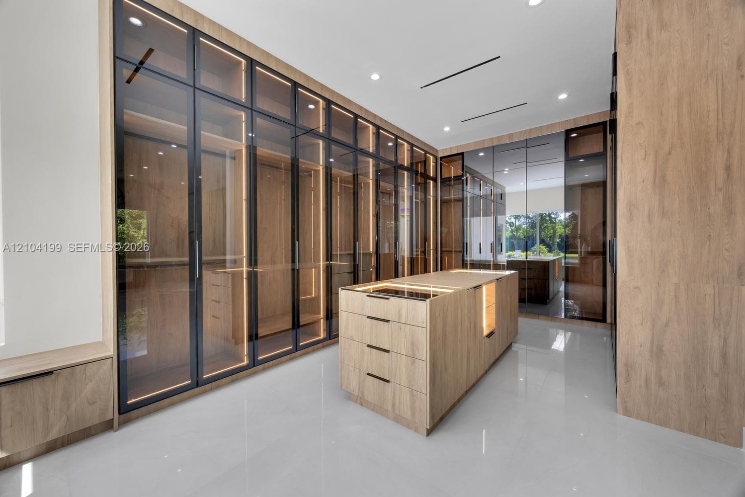 Neutral-toned interior room featuring large-format tile flooring, recessed ceiling lighting, and two windows providing natural illumination
